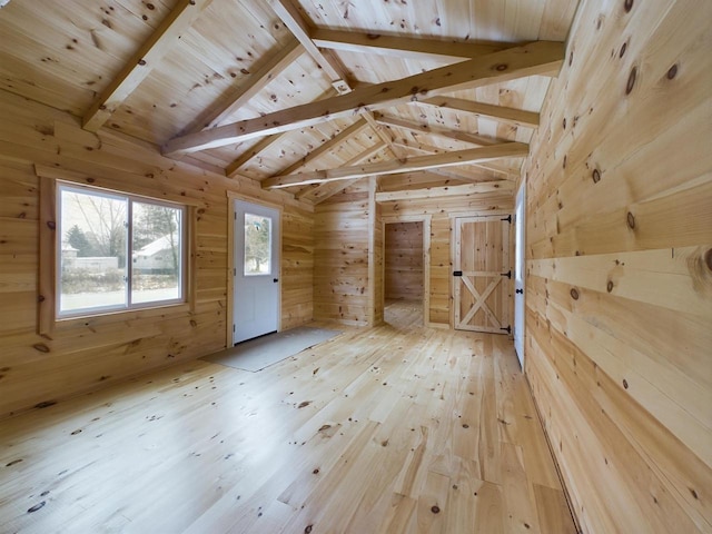 bonus room with hardwood / wood-style floors, lofted ceiling with beams, wood walls, and wood ceiling