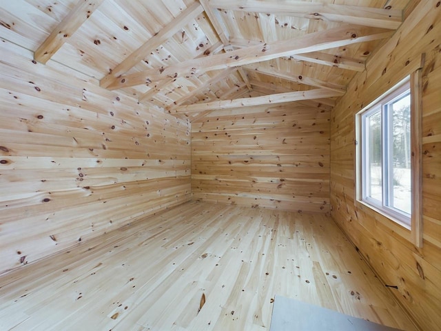 bonus room featuring vaulted ceiling with beams, wood walls, wood ceiling, and hardwood / wood-style flooring