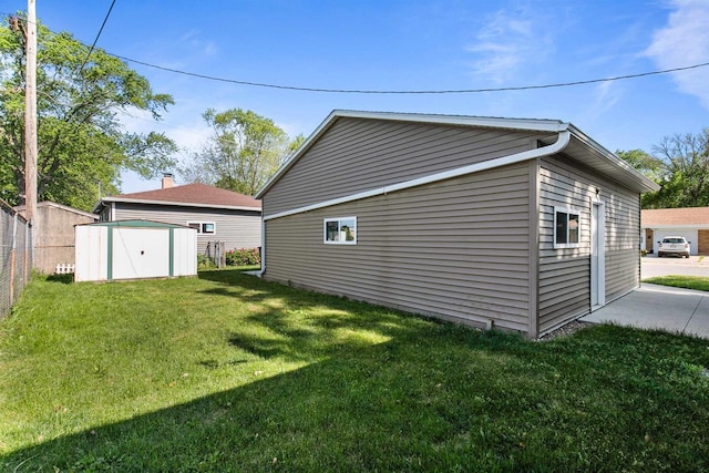 view of home's exterior featuring a lawn and a shed