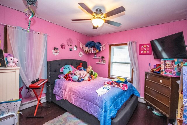 239 W Paradise Dr, West Bend, WI 53095 - bedroom featuring dark hardwood / wood-style floors, ceiling fan, and a baseboard heating unit