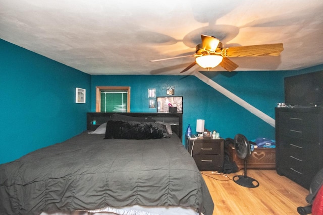 239 W Paradise Dr, West Bend, WI 53095 - bedroom featuring ceiling fan, vaulted ceiling, and light wood-type flooring