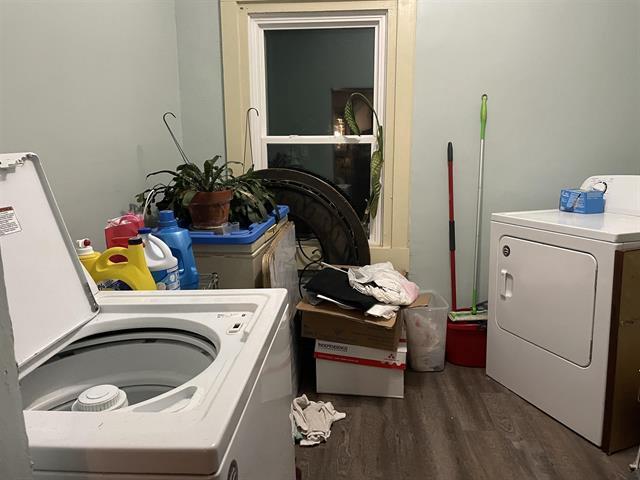 laundry room with washing machine and dryer and dark hardwood / wood-style flooring