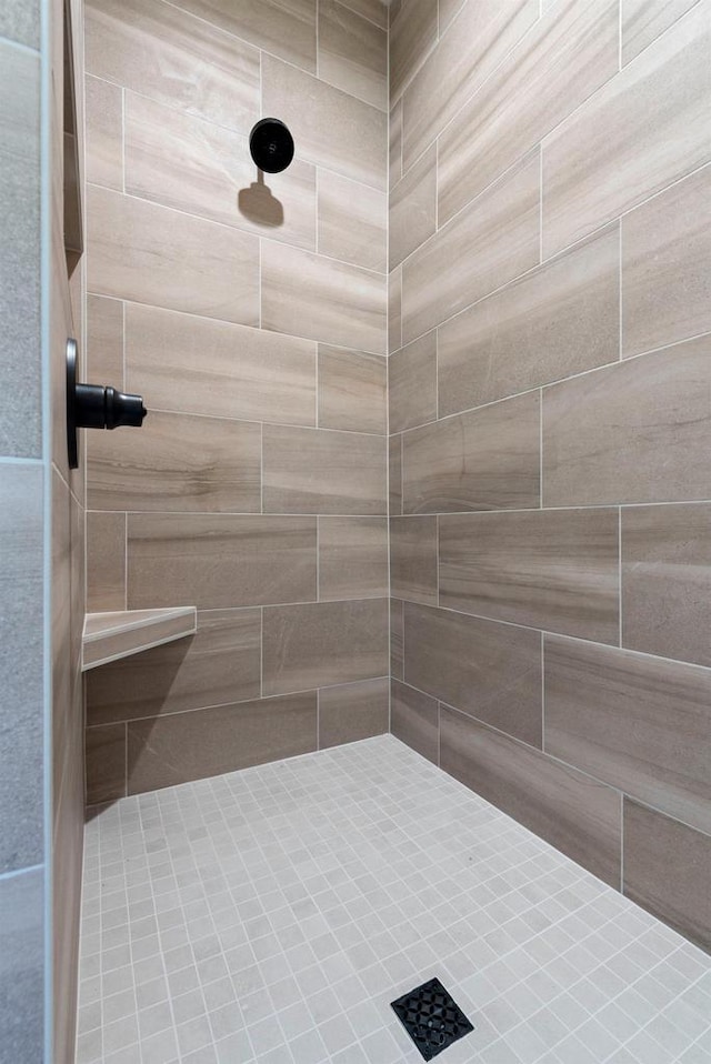 bathroom with tiled shower