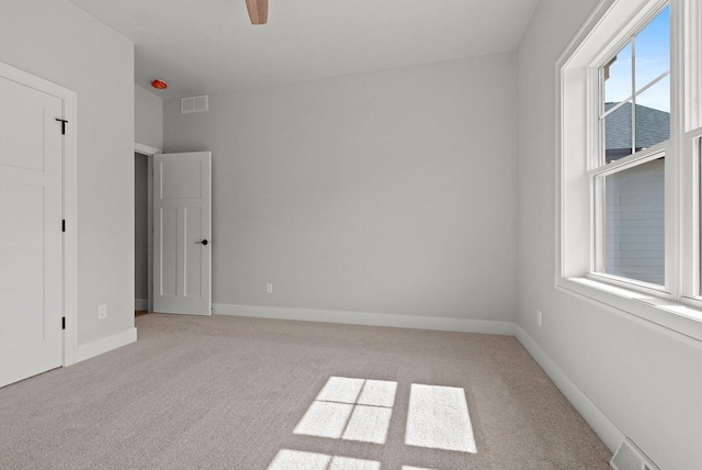 unfurnished room featuring ceiling fan and light colored carpet