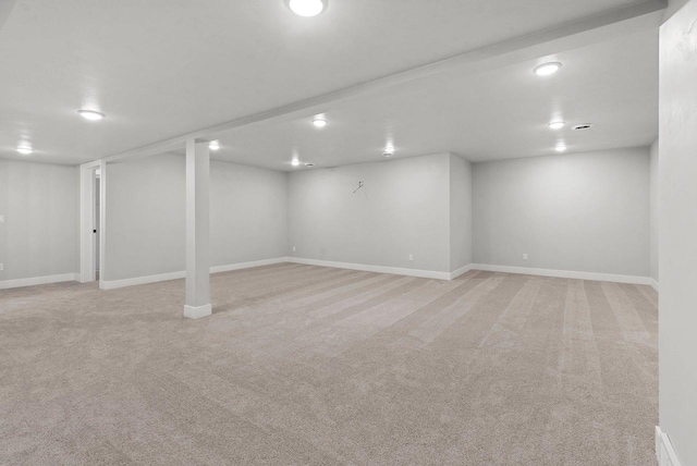 basement featuring light colored carpet