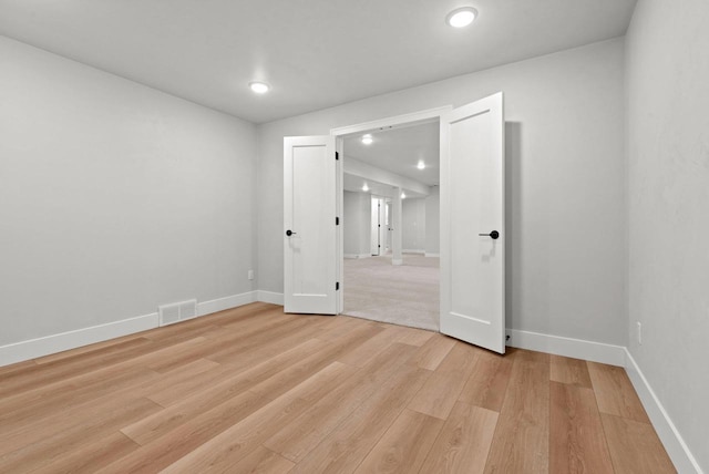 spare room featuring light hardwood / wood-style flooring