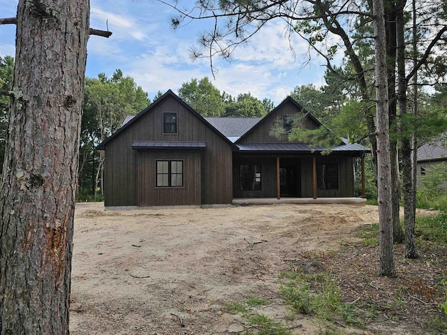 exterior space with covered porch, metal roof, and a standing seam roof