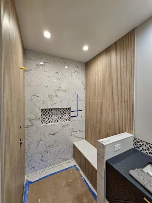 bathroom with vanity, recessed lighting, and a marble finish shower