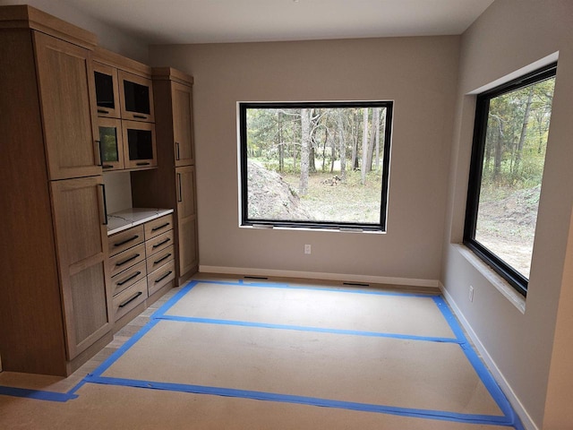 unfurnished dining area featuring plenty of natural light