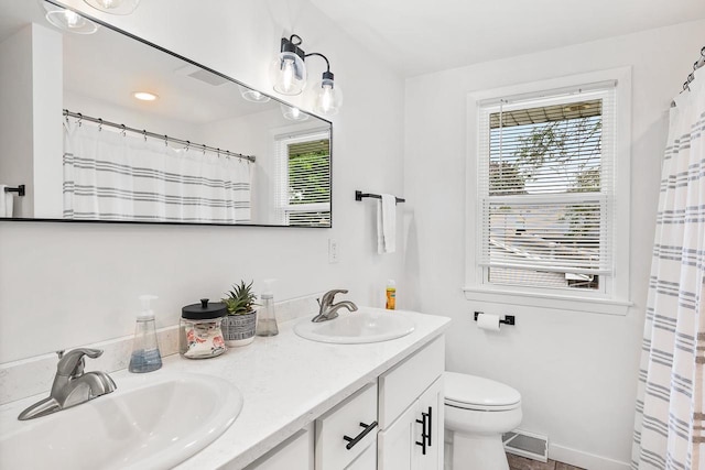 bathroom featuring vanity and toilet