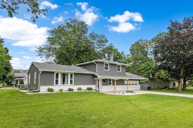 view of front of house featuring a front yard, a porch, a garage, and cooling unit