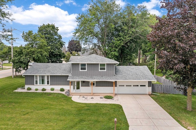 view of front of house with covered porch, a front yard, and a garage