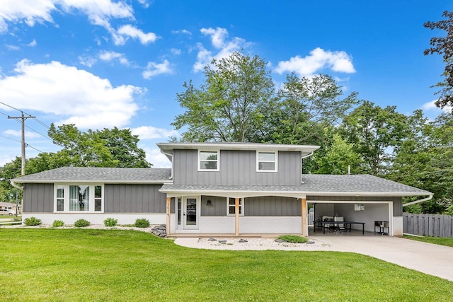 rear view of property featuring a lawn and a porch