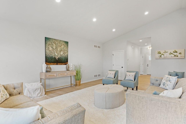 living room with light wood-type flooring and lofted ceiling