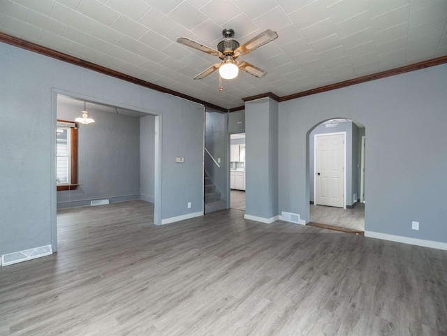 empty room featuring hardwood / wood-style flooring, ceiling fan, and crown molding