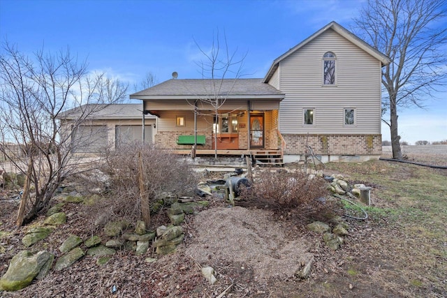 rear view of property featuring covered porch