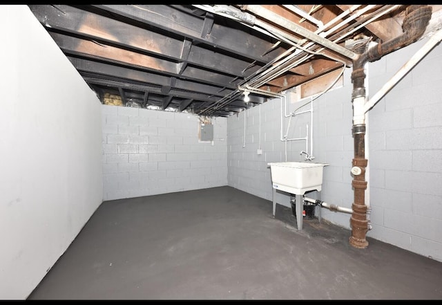 basement with sink and electric panel