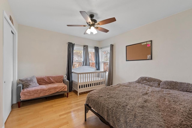 bedroom with ceiling fan, a closet, and wood-type flooring