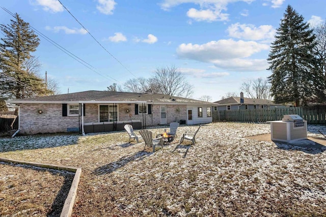 rear view of house with a fire pit