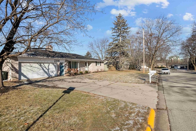 view of front of house with a front yard and a garage