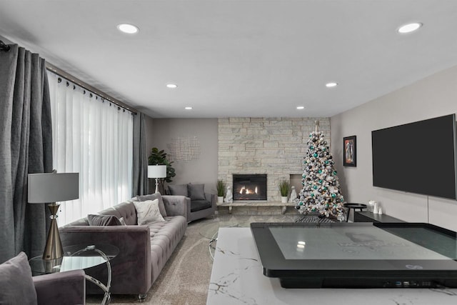 carpeted living room featuring a fireplace