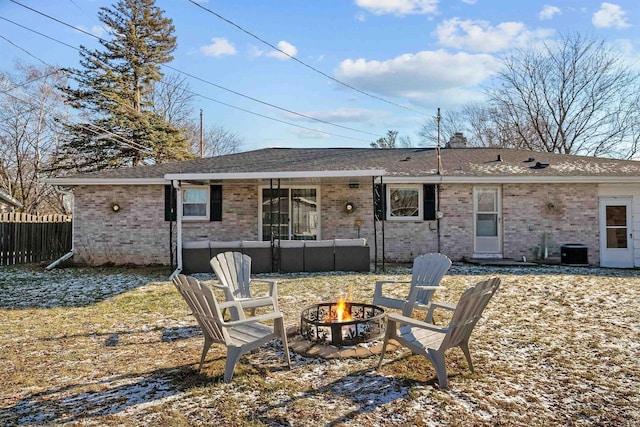 rear view of property with a fire pit