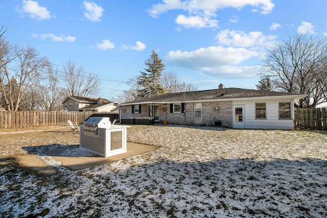 back of property featuring central AC unit and area for grilling