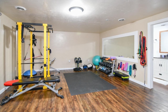 workout room with dark hardwood / wood-style floors