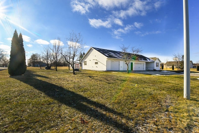 view of side of home with a garage and a yard