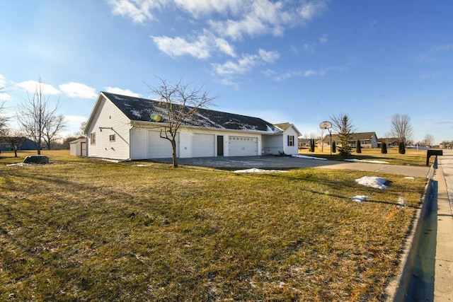 view of side of property with a garage and a yard