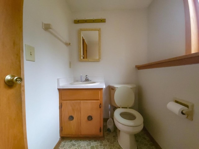 bathroom featuring tile patterned floors, vanity, and toilet