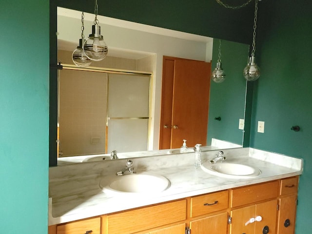 bathroom with a shower with door and vanity