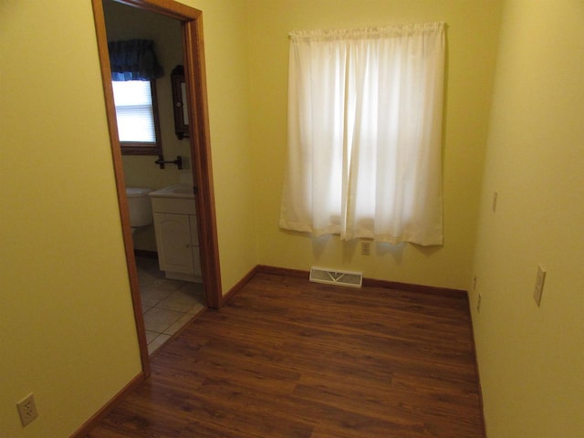 spare room featuring dark hardwood / wood-style flooring