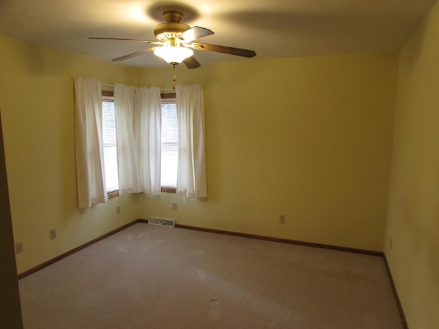 carpeted empty room featuring ceiling fan