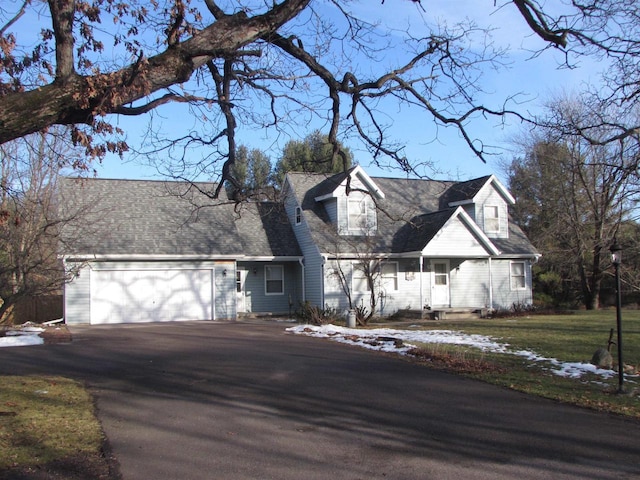 cape cod house featuring a garage