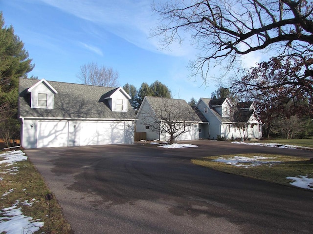 cape cod house featuring a garage