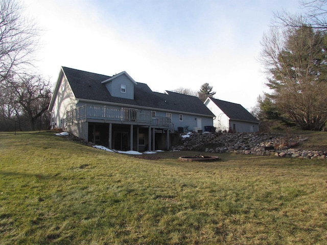 back of house with a yard and a deck