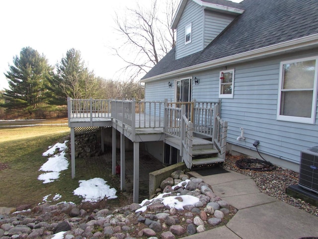 wooden terrace featuring a lawn