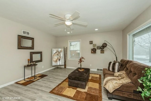 sitting room with light hardwood / wood-style floors and ceiling fan