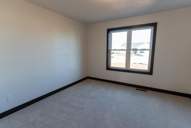 unfurnished room with carpet floors