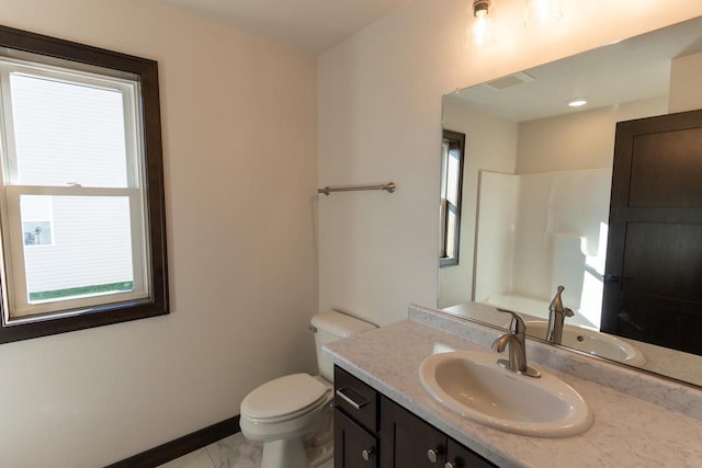 bathroom featuring a shower, vanity, and toilet