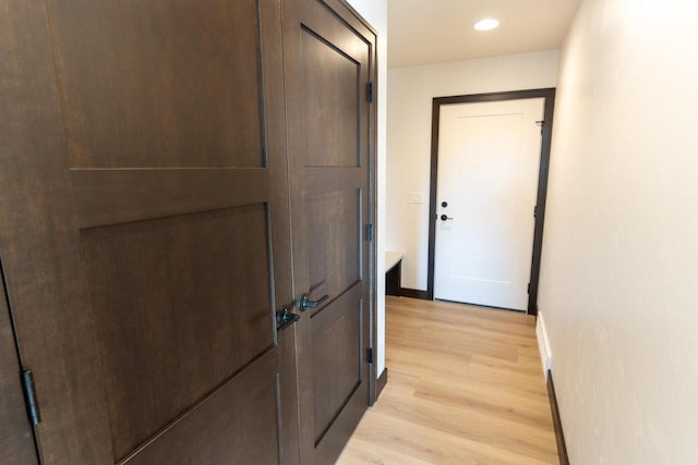 corridor with light hardwood / wood-style floors