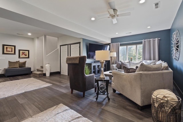 living room with ceiling fan and dark wood-type flooring