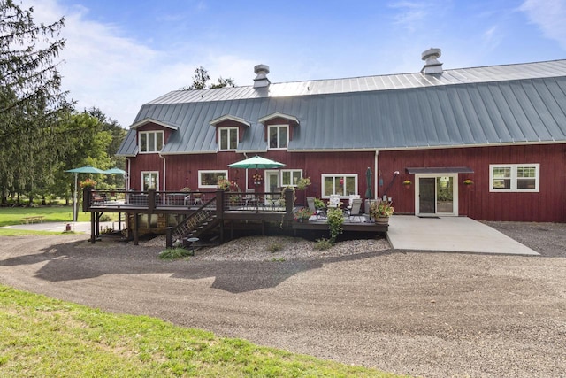 rear view of house with a wooden deck