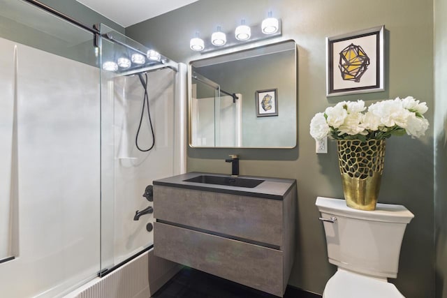 full bathroom with vanity, enclosed tub / shower combo, and toilet