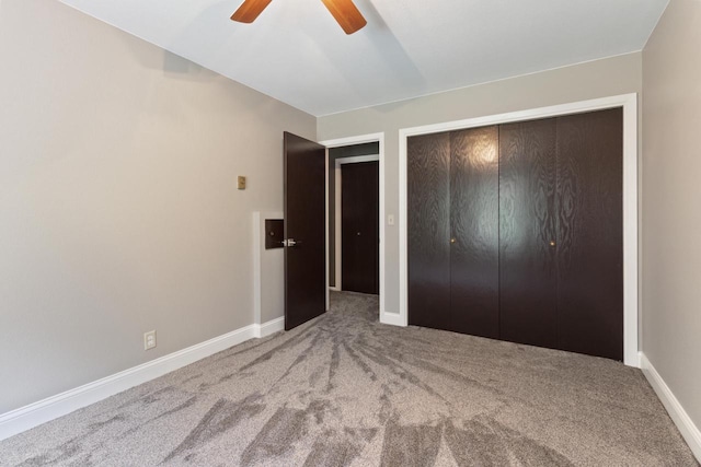 unfurnished bedroom with carpet, ceiling fan, and a closet