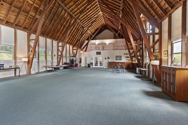 misc room featuring carpet flooring and high vaulted ceiling