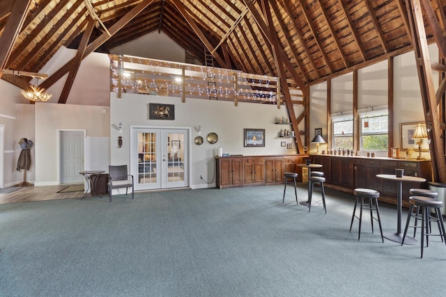 misc room featuring carpet, french doors, high vaulted ceiling, and beam ceiling