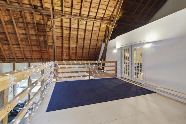 interior space with french doors and high vaulted ceiling