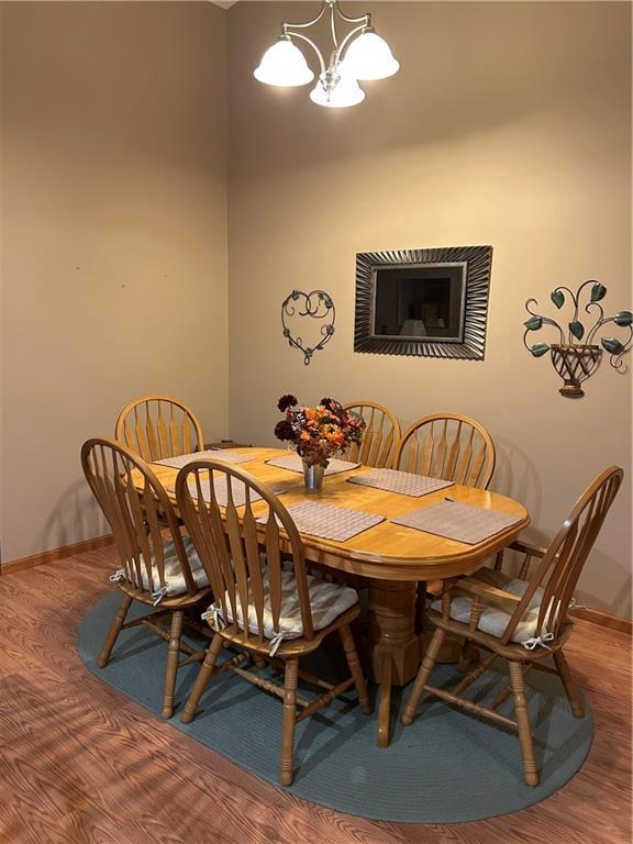 dining room featuring hardwood / wood-style floors and a chandelier